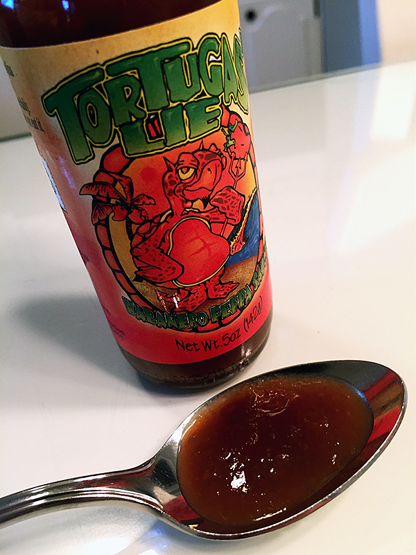 Tortugas' Lie Habanero Peppa Sauce on a spoon